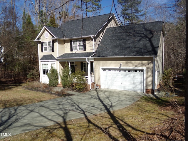 traditional-style house with driveway, a porch, an attached garage, and a shingled roof