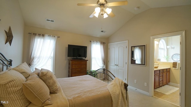 bedroom featuring lofted ceiling, a closet, visible vents, and ensuite bathroom