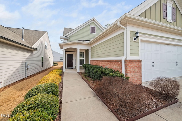 doorway to property featuring board and batten siding and brick siding