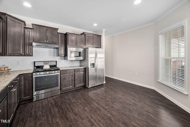 kitchen featuring stainless steel appliances, tasteful backsplash, dark brown cabinetry, and under cabinet range hood