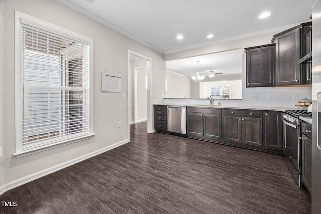 kitchen featuring dark brown cabinets, appliances with stainless steel finishes, dark wood finished floors, and crown molding