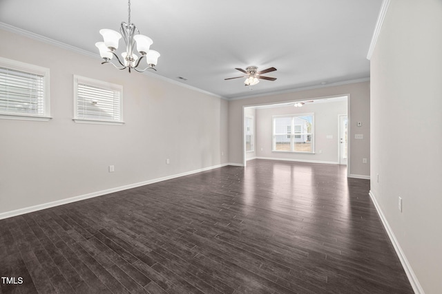 unfurnished living room with dark wood-style floors, a wealth of natural light, and ornamental molding