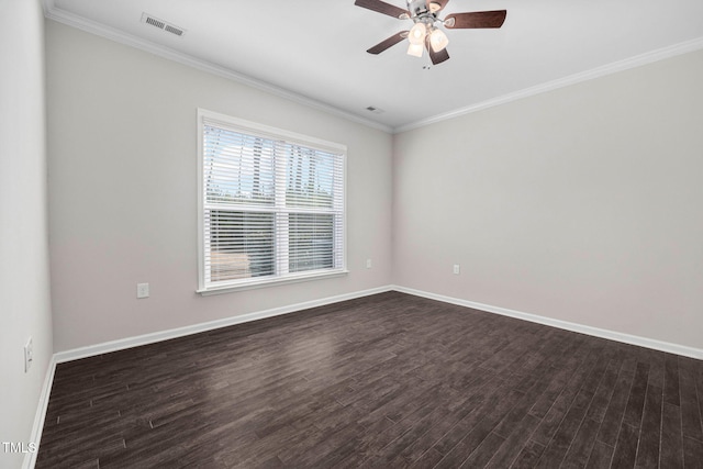 empty room with baseboards, crown molding, visible vents, and dark wood-type flooring