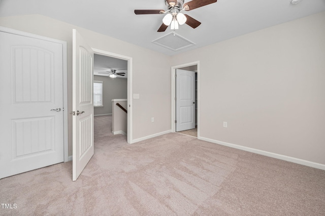 unfurnished bedroom with light carpet, a ceiling fan, and baseboards