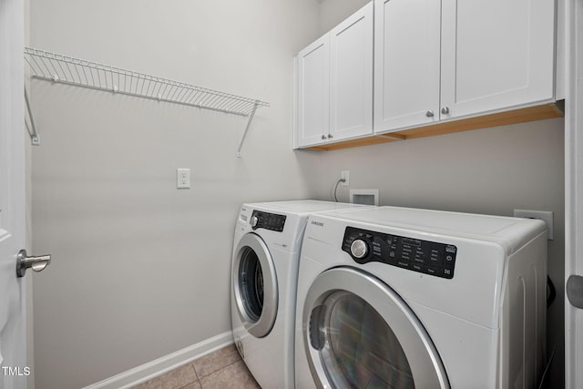 laundry room featuring cabinet space, independent washer and dryer, baseboards, and light tile patterned floors