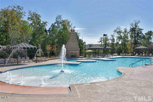 view of swimming pool featuring a patio area