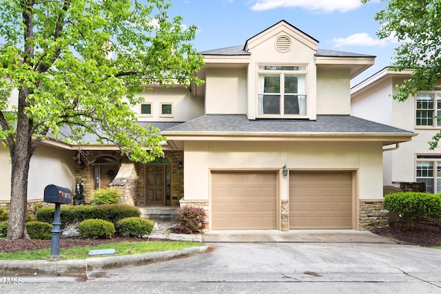 view of front of home featuring concrete driveway, stucco siding, stone siding, and an attached garage
