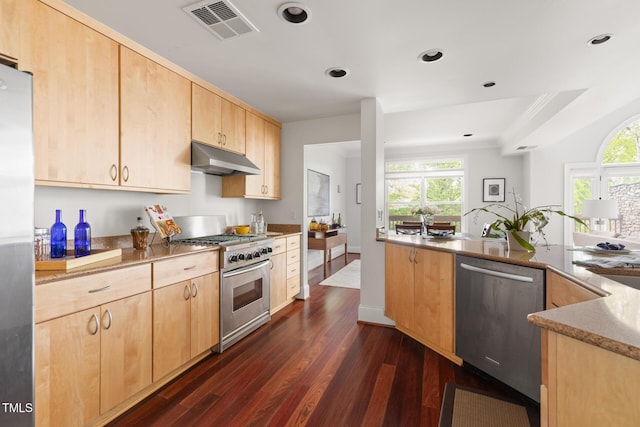 kitchen with visible vents, light brown cabinetry, dark wood-style floors, under cabinet range hood, and stainless steel appliances