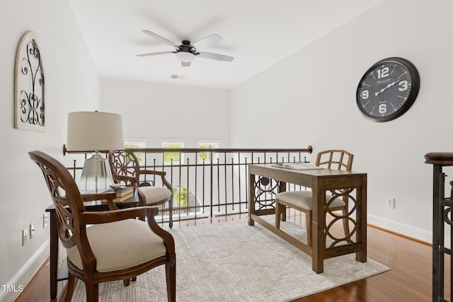 sitting room with visible vents, ceiling fan, wood finished floors, and baseboards