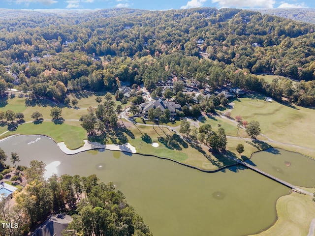 aerial view with a water view, a wooded view, and view of golf course