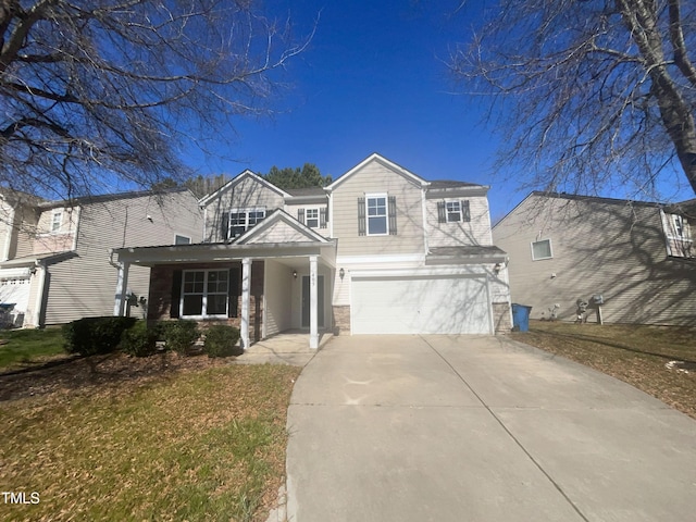 view of front facade with concrete driveway, an attached garage, and a front yard