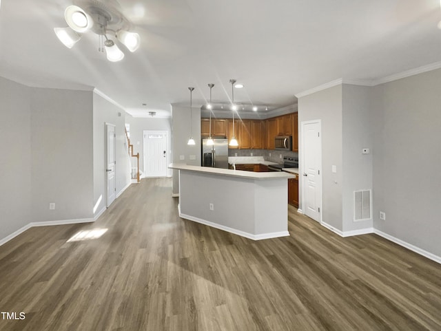 kitchen featuring stainless steel appliances, tasteful backsplash, light countertops, visible vents, and dark wood-type flooring