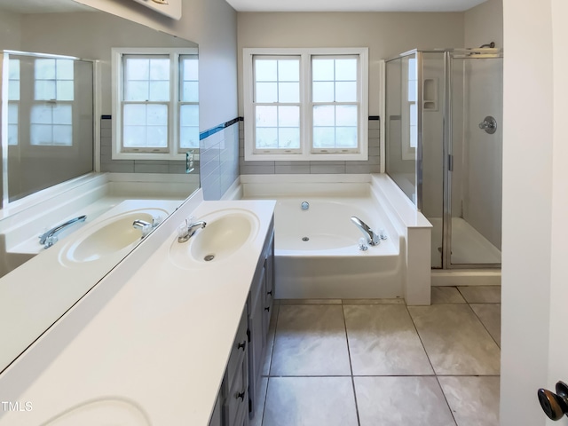 bathroom with double vanity, a garden tub, a sink, and a stall shower