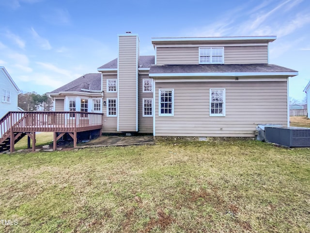 back of property featuring cooling unit, a shingled roof, a yard, a wooden deck, and a chimney