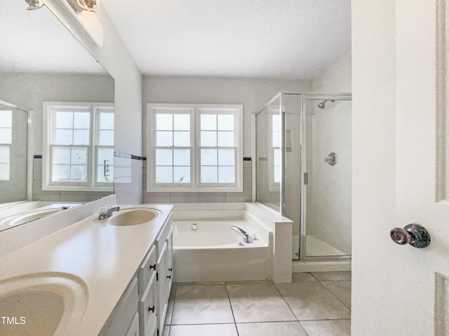 5317 Tifton Dr, Raleigh, NC 27610 - bathroom with a garden tub, double vanity, a shower stall, and tile patterned flooring