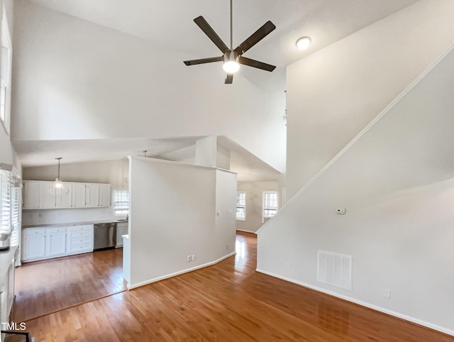 5317 Tifton Dr, Raleigh, NC 27610 - unfurnished living room with high vaulted ceiling, ceiling fan, plenty of natural light, and light wood-style floors