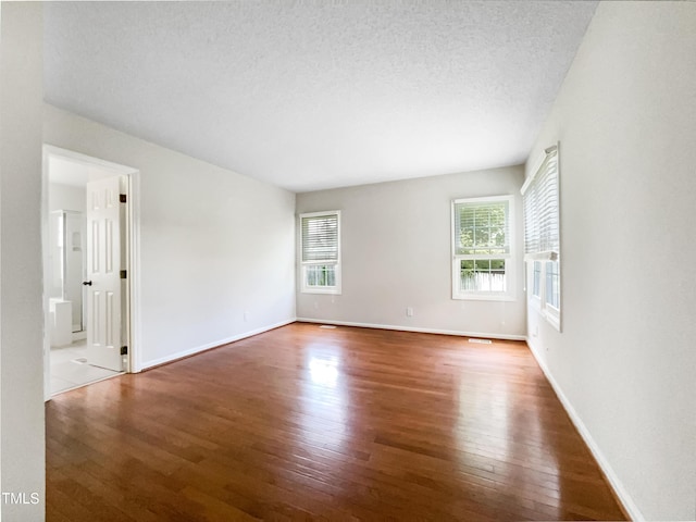 5317 Tifton Dr, Raleigh, NC 27610 - empty room with hardwood / wood-style floors and a textured ceiling