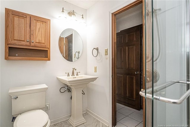 bathroom featuring baseboards, toilet, and an enclosed shower