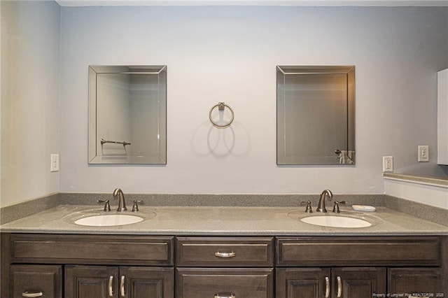 full bath featuring double vanity and a sink