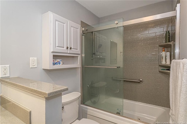 bathroom featuring shower / bath combination with glass door and toilet