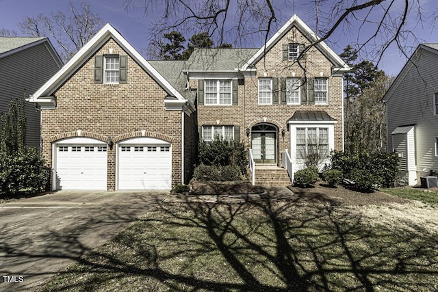 colonial-style house with concrete driveway, brick siding, and central air condition unit