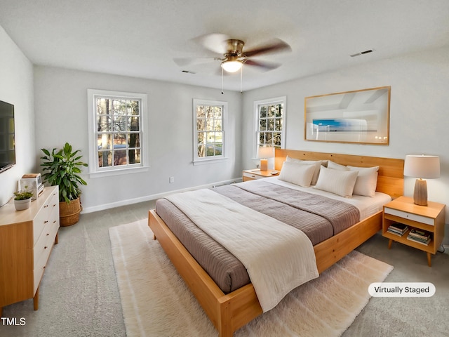 bedroom featuring baseboards, visible vents, a ceiling fan, and light colored carpet