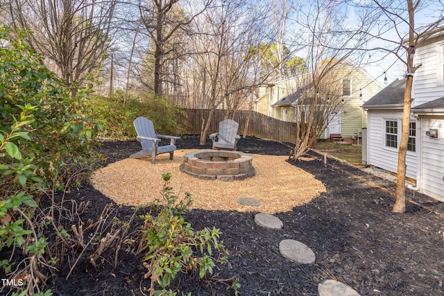 view of yard featuring fence and a fire pit