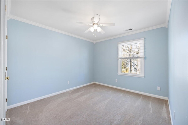 carpeted empty room featuring ornamental molding, visible vents, ceiling fan, and baseboards