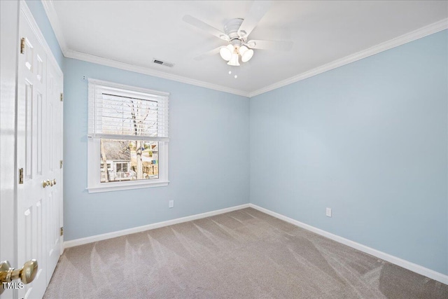 unfurnished bedroom with baseboards, visible vents, carpet, crown molding, and a closet