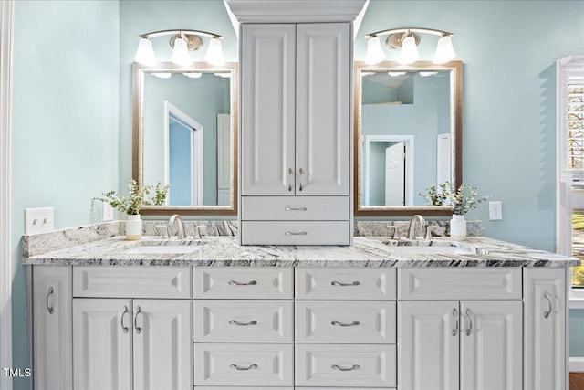 full bathroom with double vanity and a sink