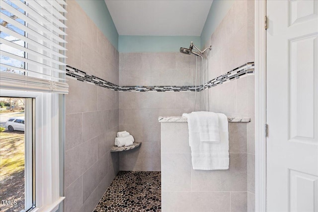 bathroom with a tile shower