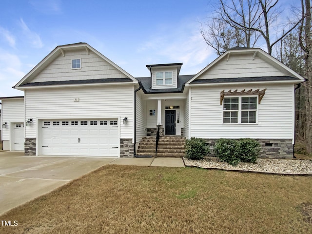 craftsman inspired home featuring concrete driveway, roof with shingles, an attached garage, and a front lawn