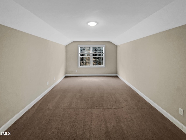 additional living space with lofted ceiling, carpet flooring, and baseboards