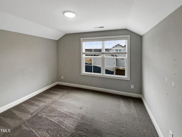 bonus room with lofted ceiling, carpet floors, visible vents, and baseboards