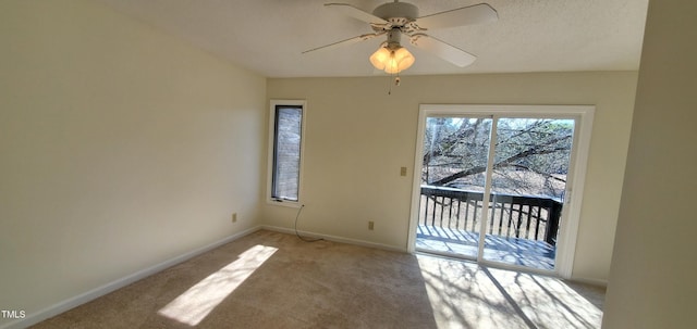 empty room featuring light carpet, ceiling fan, a textured ceiling, and baseboards