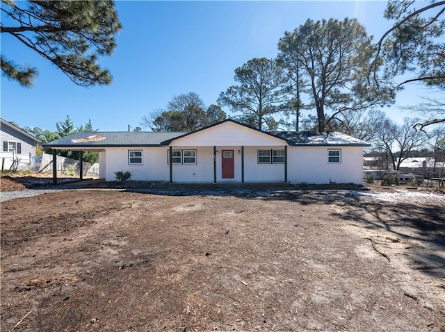 ranch-style house featuring an attached carport