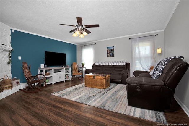 living room with a textured ceiling, dark wood-type flooring, plenty of natural light, and ornamental molding