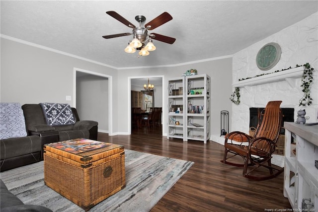 living room with dark wood-style floors, ornamental molding, a textured ceiling, and ceiling fan with notable chandelier