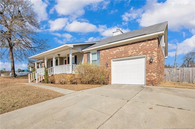 ranch-style house featuring driveway, a chimney, an attached garage, covered porch, and brick siding