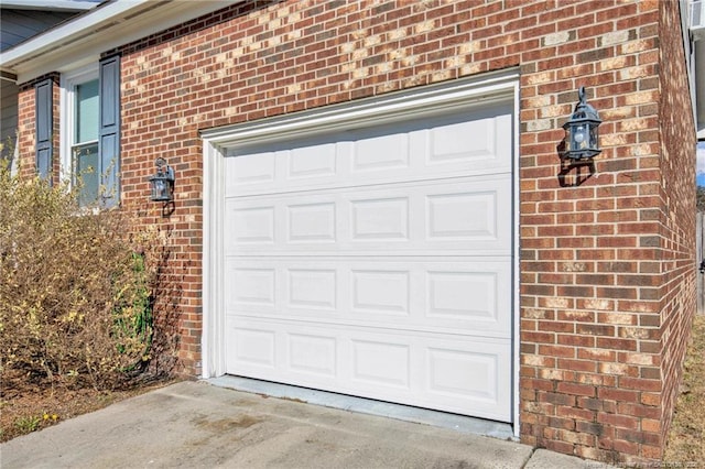 garage featuring concrete driveway