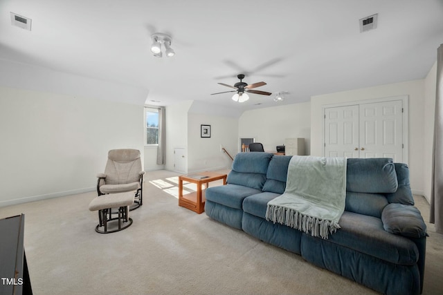 carpeted living room with baseboards, visible vents, and ceiling fan