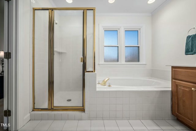 bathroom with a garden tub, ornamental molding, vanity, a shower stall, and tile patterned flooring