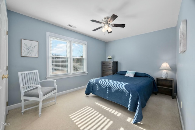 bedroom with light carpet, baseboards, visible vents, and a ceiling fan