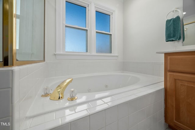 bathroom featuring a whirlpool tub and vanity