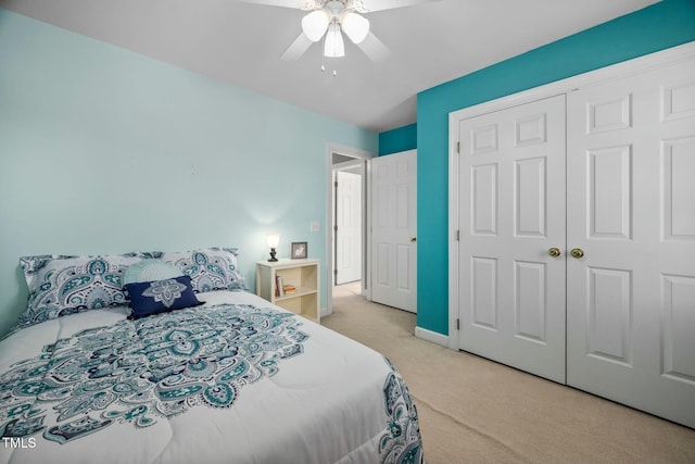 bedroom featuring a ceiling fan, a closet, light carpet, and baseboards