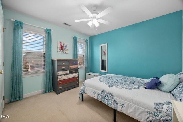 bedroom featuring a ceiling fan, baseboards, visible vents, and carpet flooring