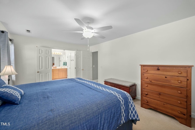 bedroom with a ceiling fan, light carpet, connected bathroom, and visible vents