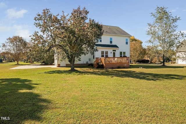 back of house featuring a deck and a yard