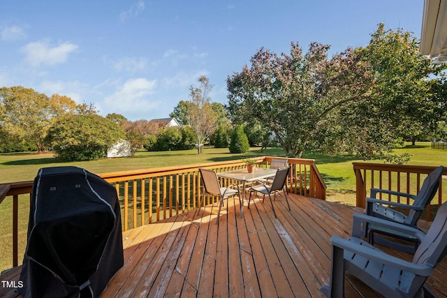 wooden terrace with a yard, outdoor dining space, and grilling area