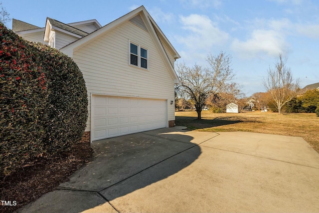 view of property exterior with a lawn and an attached garage